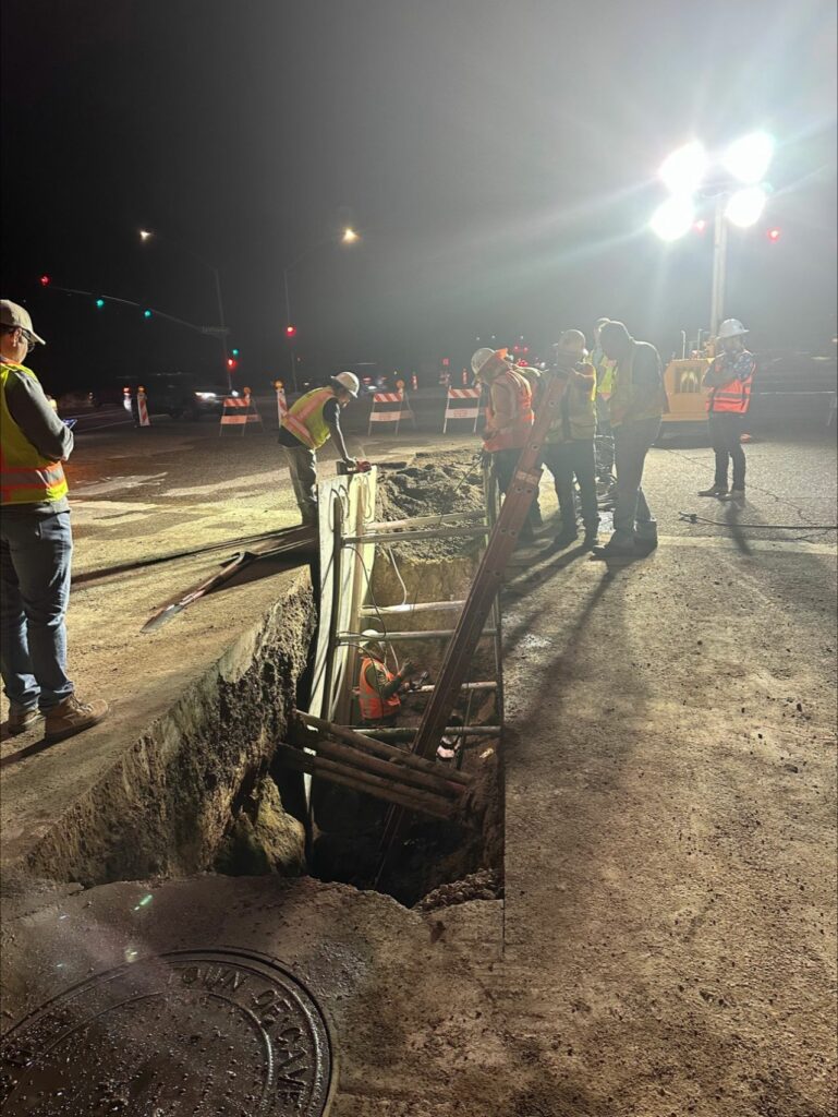 Field crew assessing trench on the ground