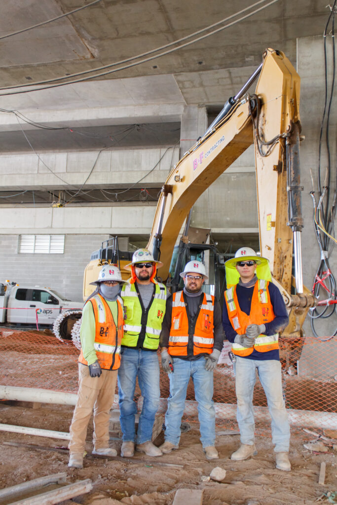 Crew smiling for photo in jobsite