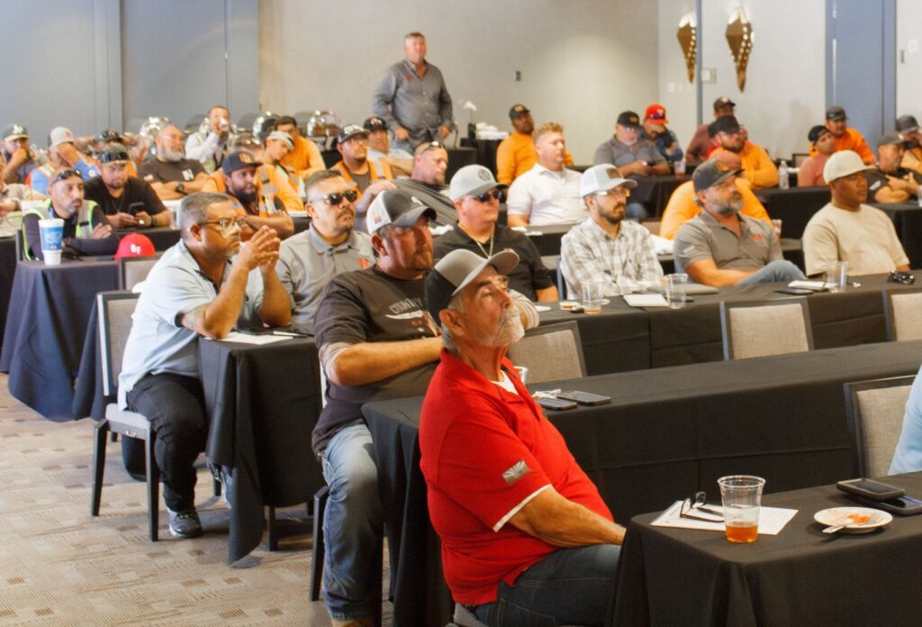 People in a conference room listening to a presentation