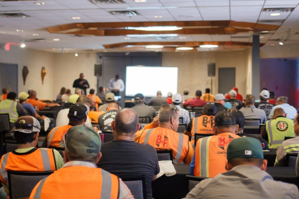 People in a conference room listening to a presentation