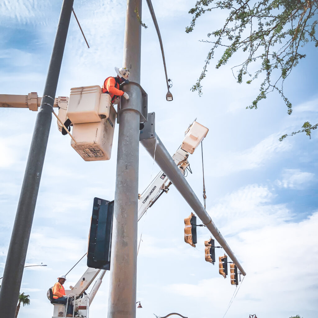 Crew member installing a traffic signal