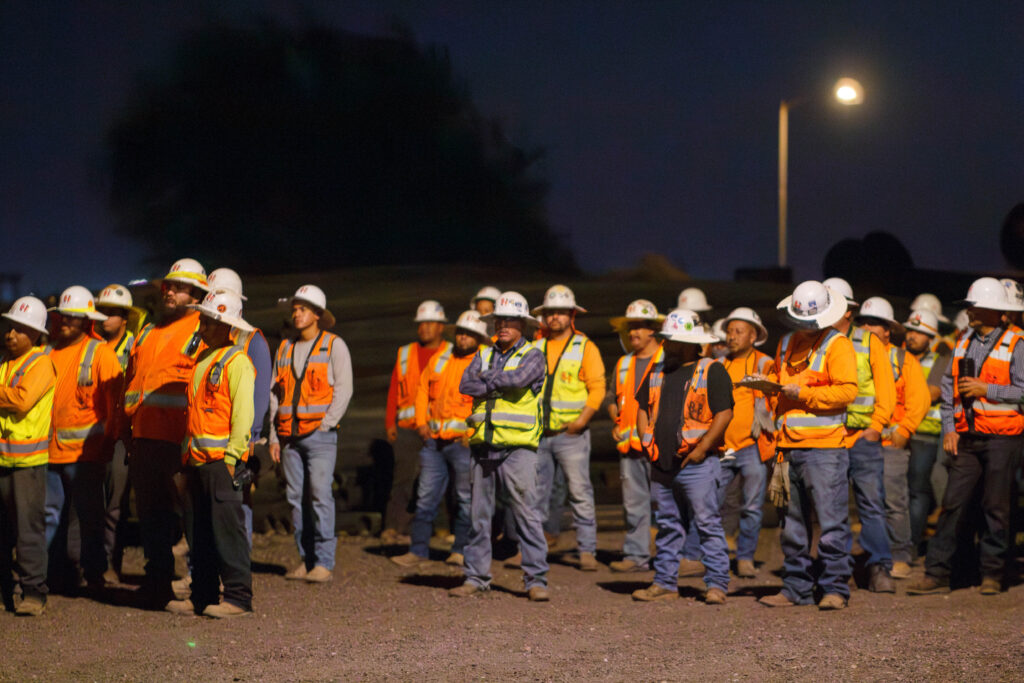 Construction workers standing in a meeting