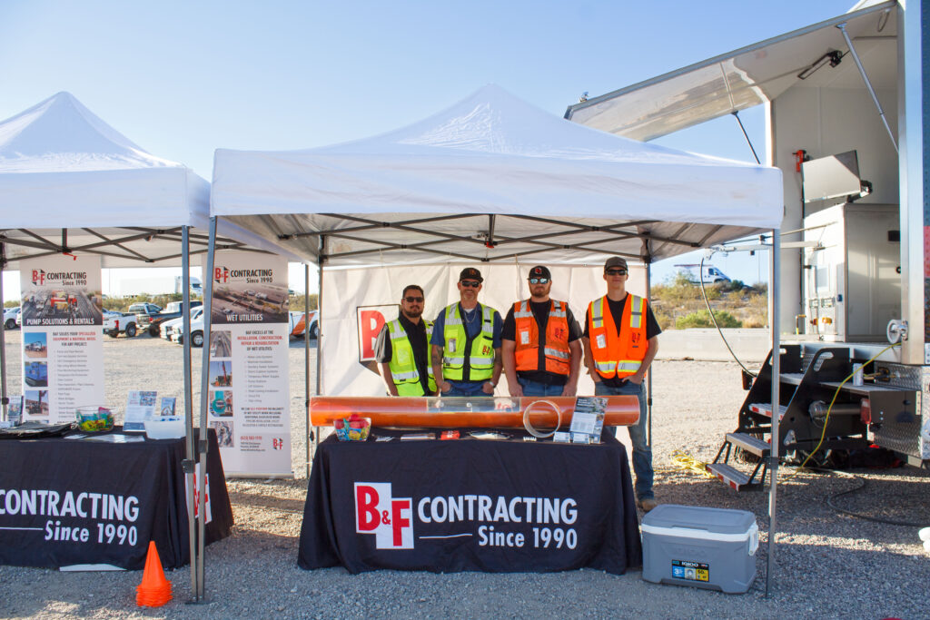 Construction workers standing at a booth