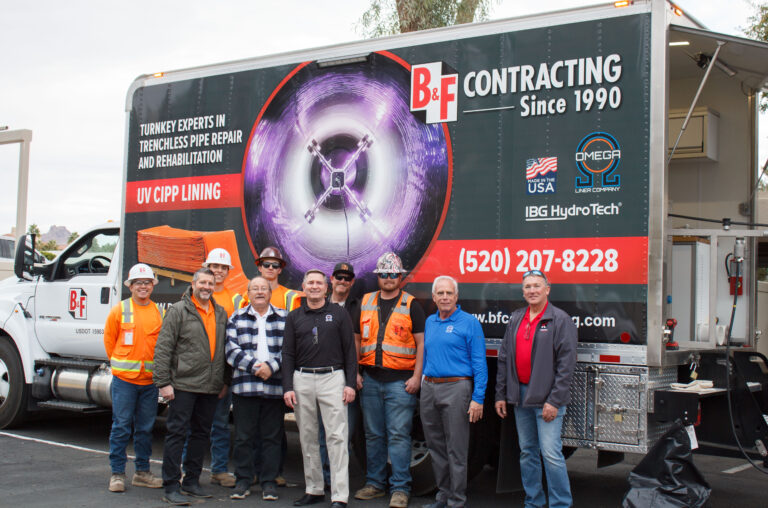 People standing in front of a large truck