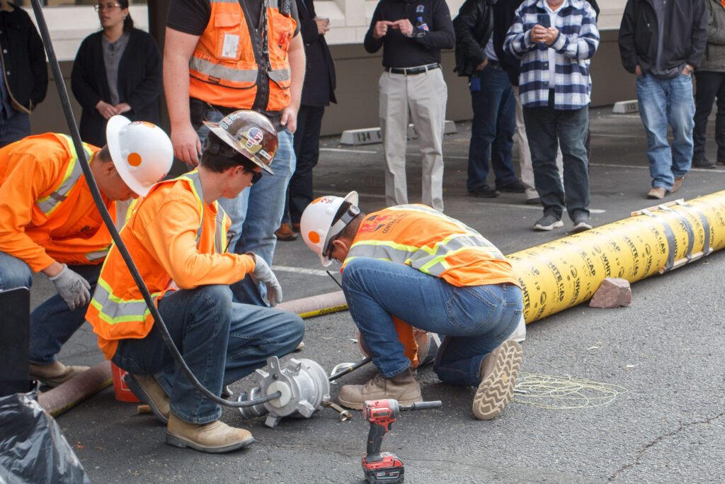 Workers installing pipe