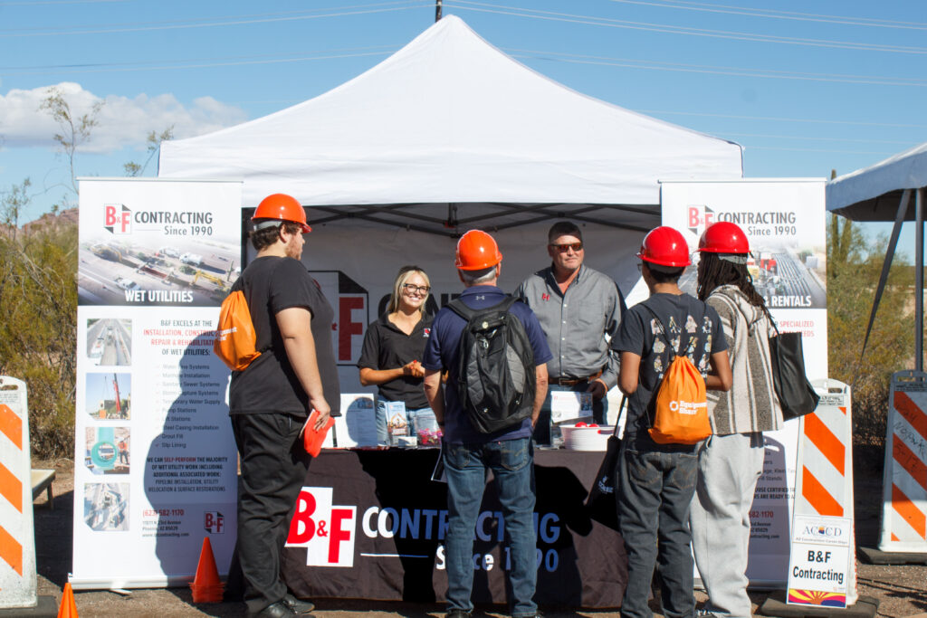 People standing around a booth