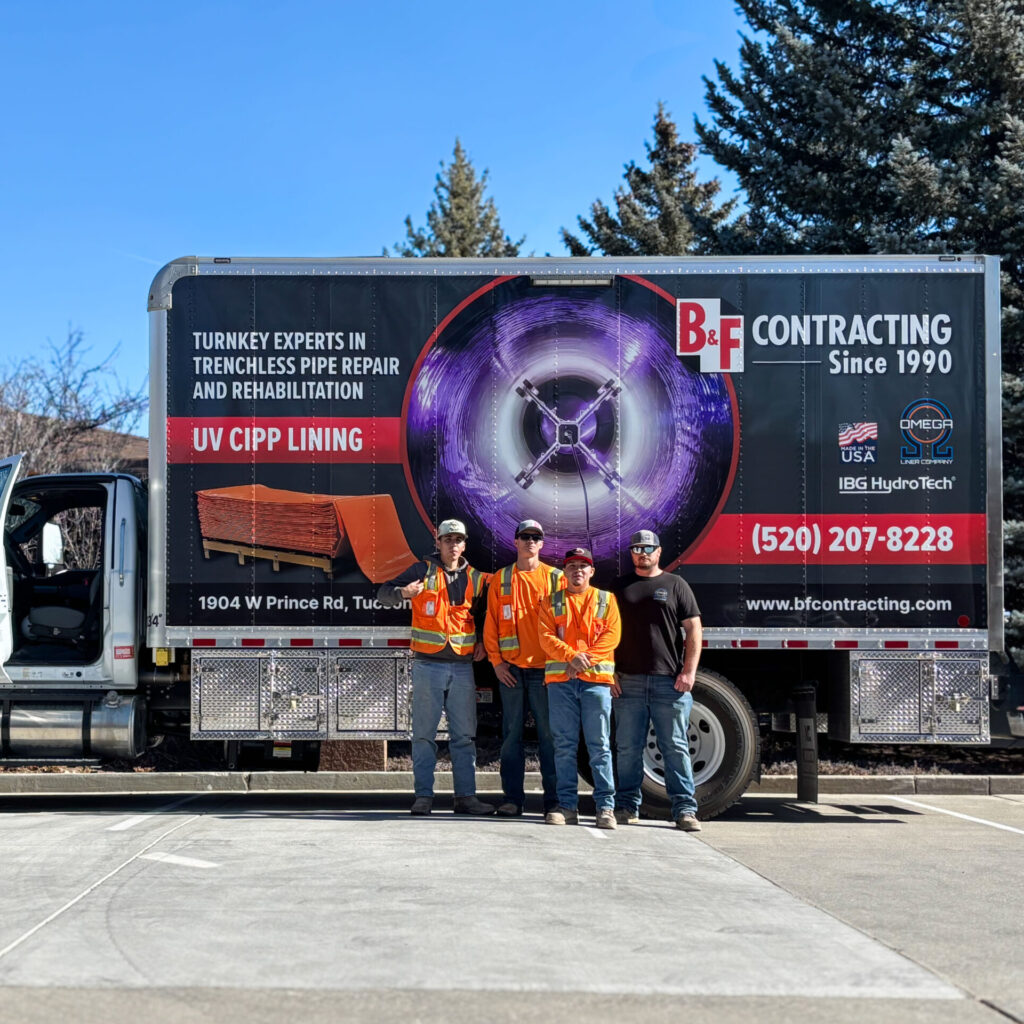 Crew posing in front of truck