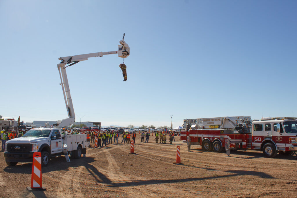 open field with a fire truck and a crane